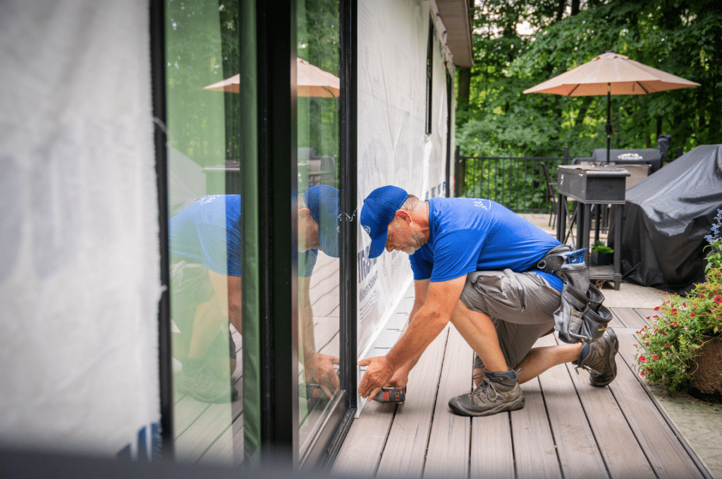 Man taking measurements to install siding.